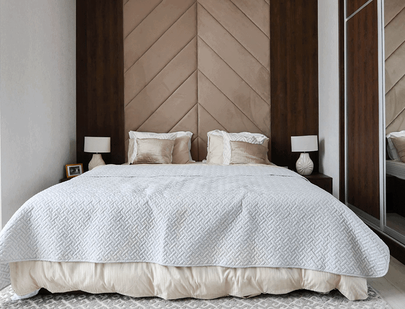 A bedroom with a wooden headboard available for rent in Bahrain through House Me Bahrain company.