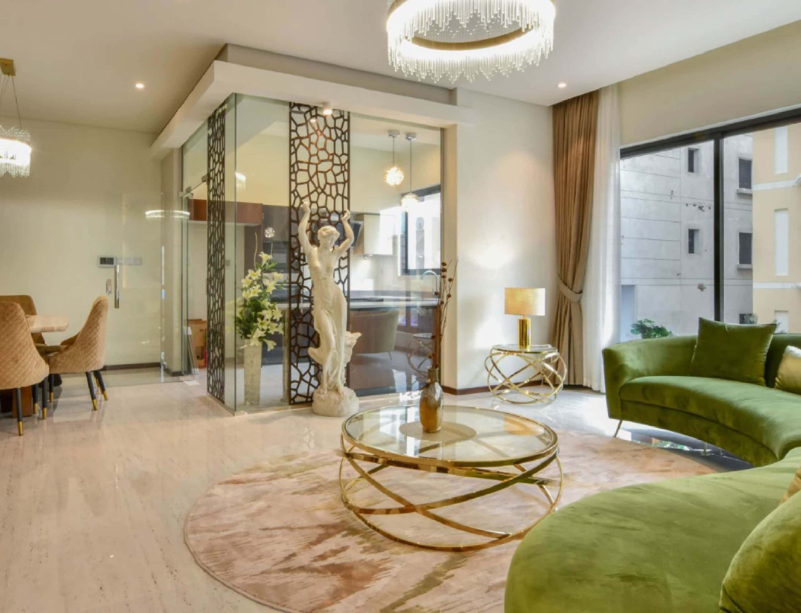 House Me Bahrain company is the us-based real estate business for finding rented accommodations, offering a wide selection of houses including a living room with green couches and a glass table.