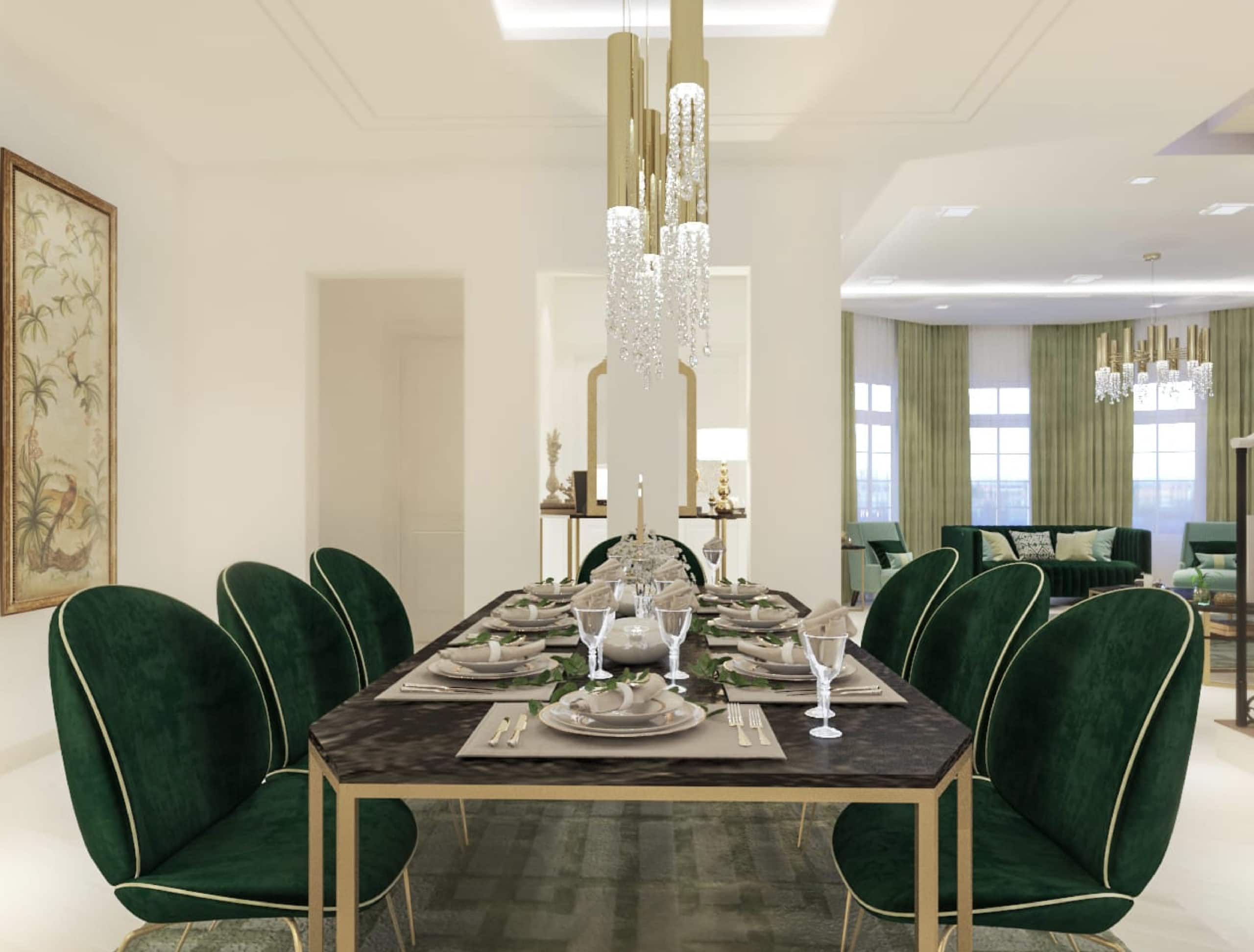 Luxury dining room with green chairs and a gold chandelier in a 4BR villa for sale in Durrat Al Muharraq with garden.