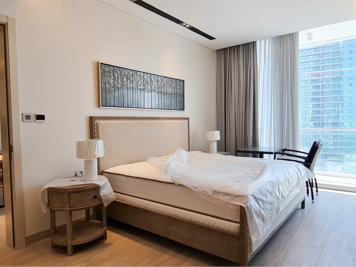 A fully furnished bedroom with an amazing view of the city.