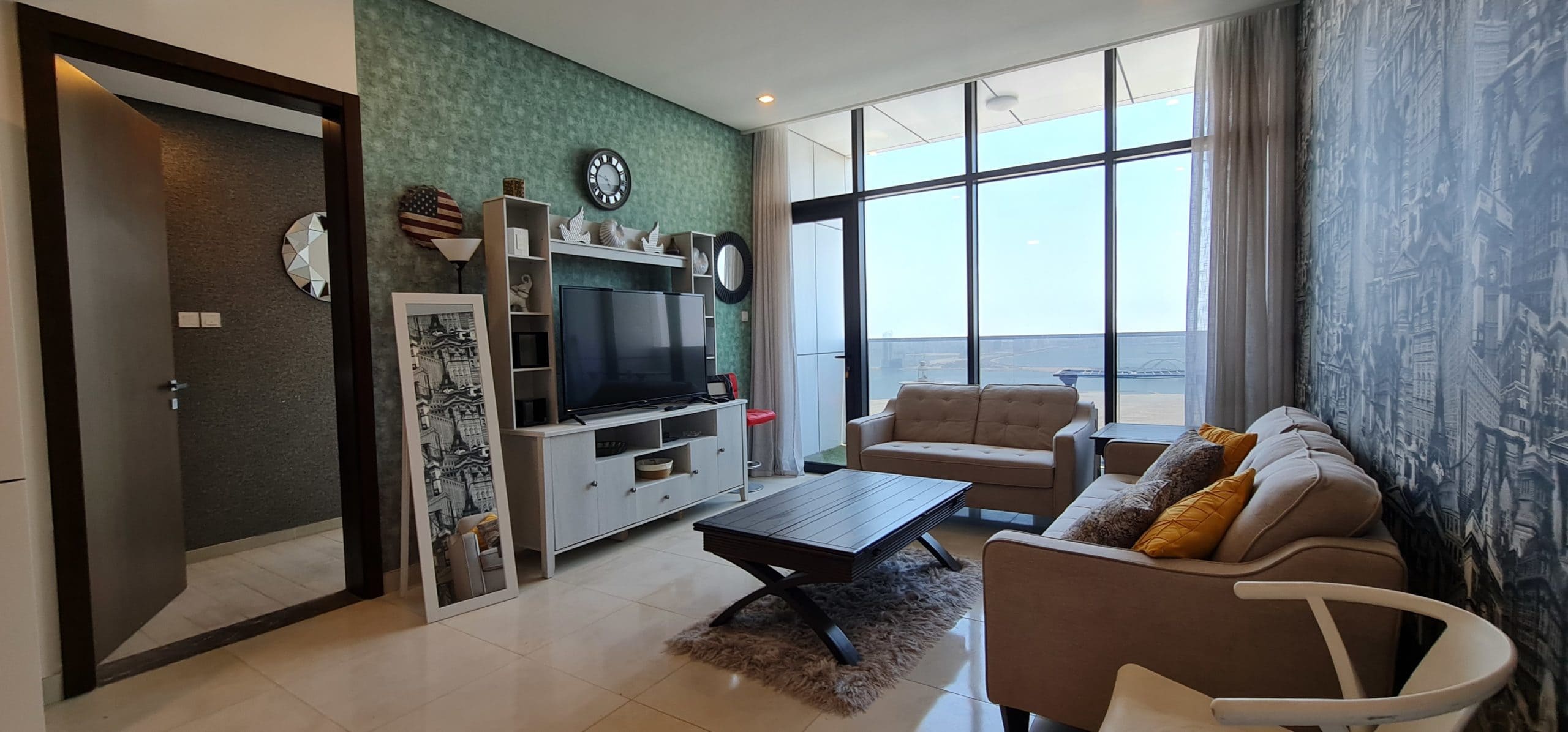 A modern apartment for rent in Juffair with a stunning view of the ocean.