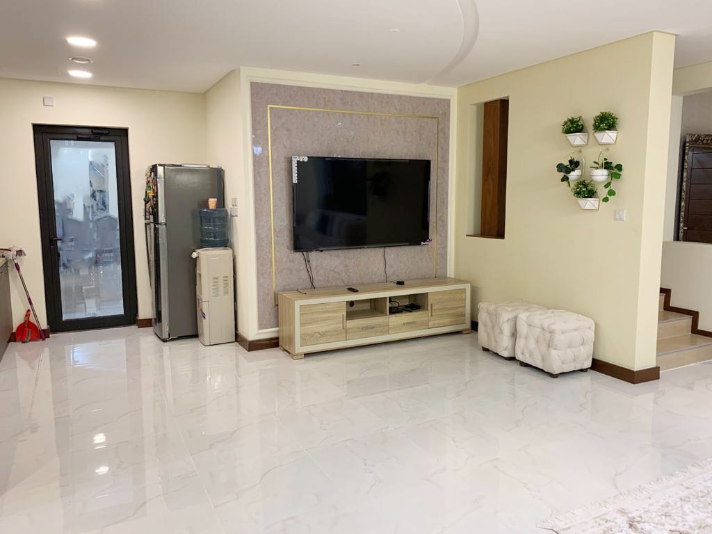 An amazing living room with a TV and a TV stand.