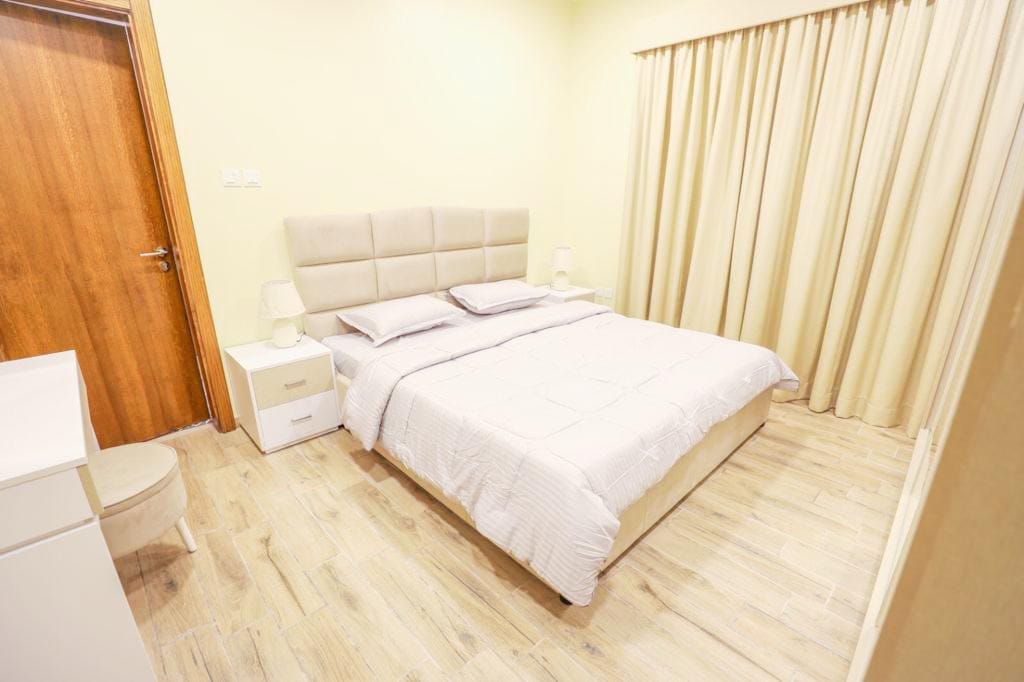 Keywords: bedroom, white bed, wooden floors.

Description: A bedroom with a stylish white bed and beautifully crafted wooden floors.