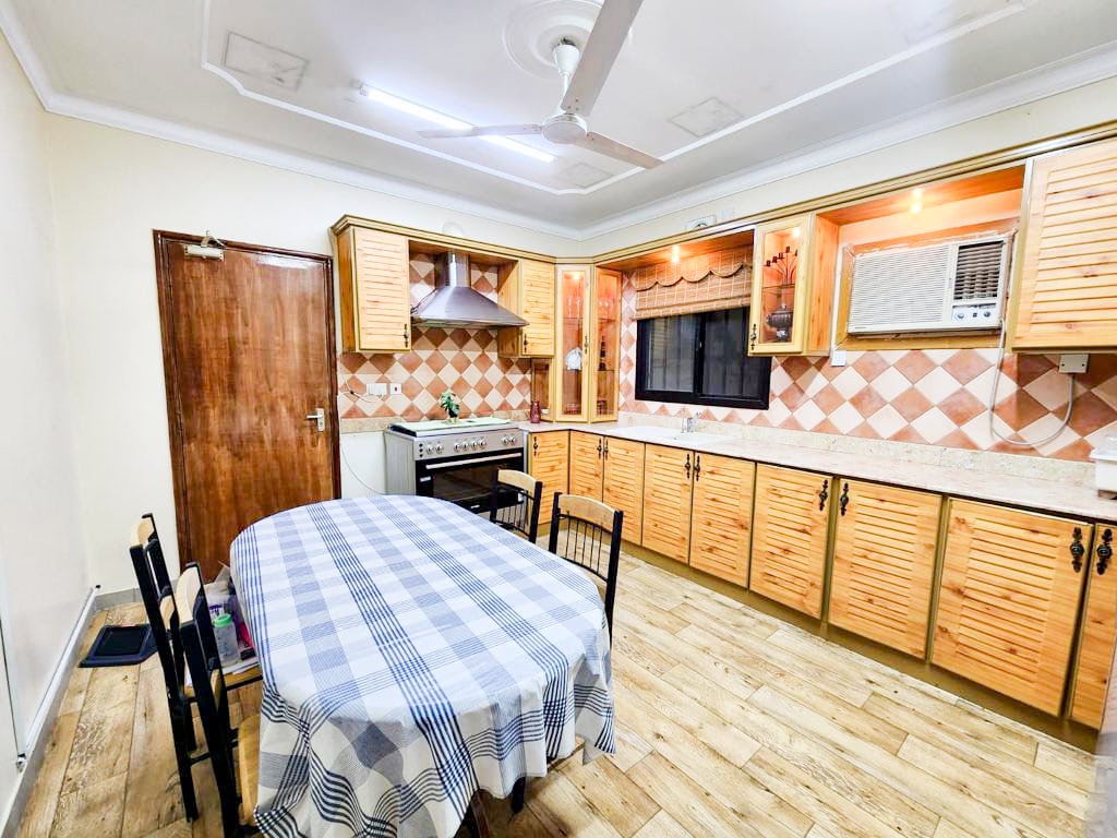 A luxury villa with wooden cabinets and a checkered tablecloth.