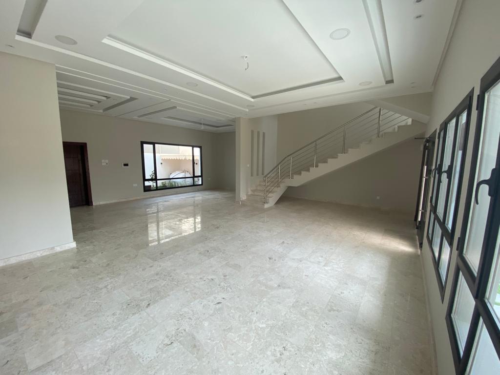 A luxurious large house with marble floors and stairs.