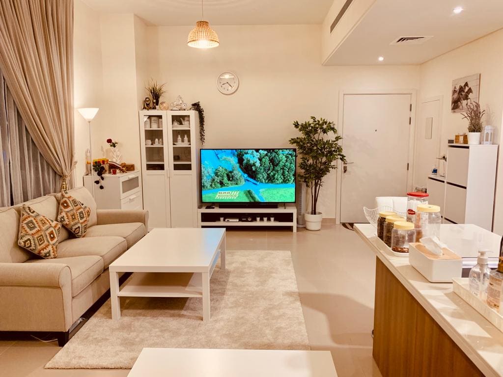 A luxurious living room with a tv and a couch.