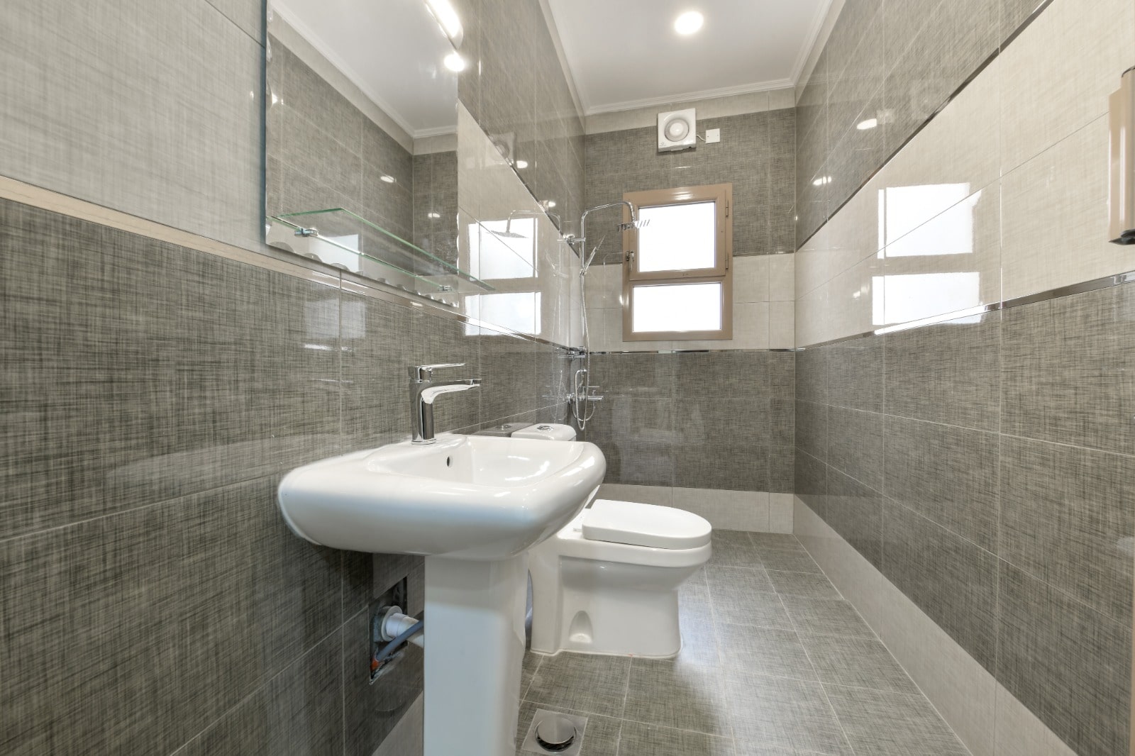 Amazing bathroom with sink, toilet and mirror.