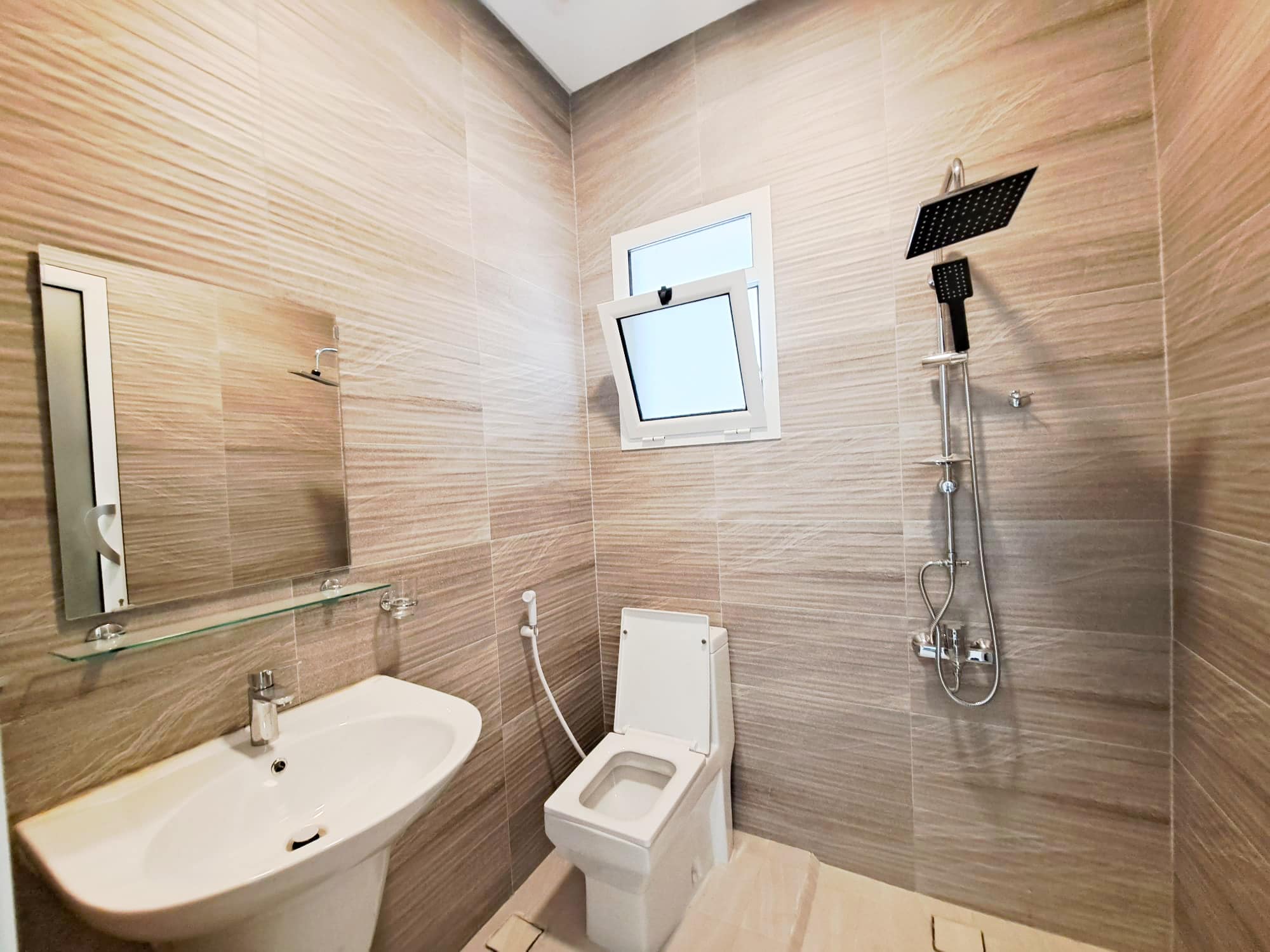 A luxurious bathroom with a toilet, sink, and shower.