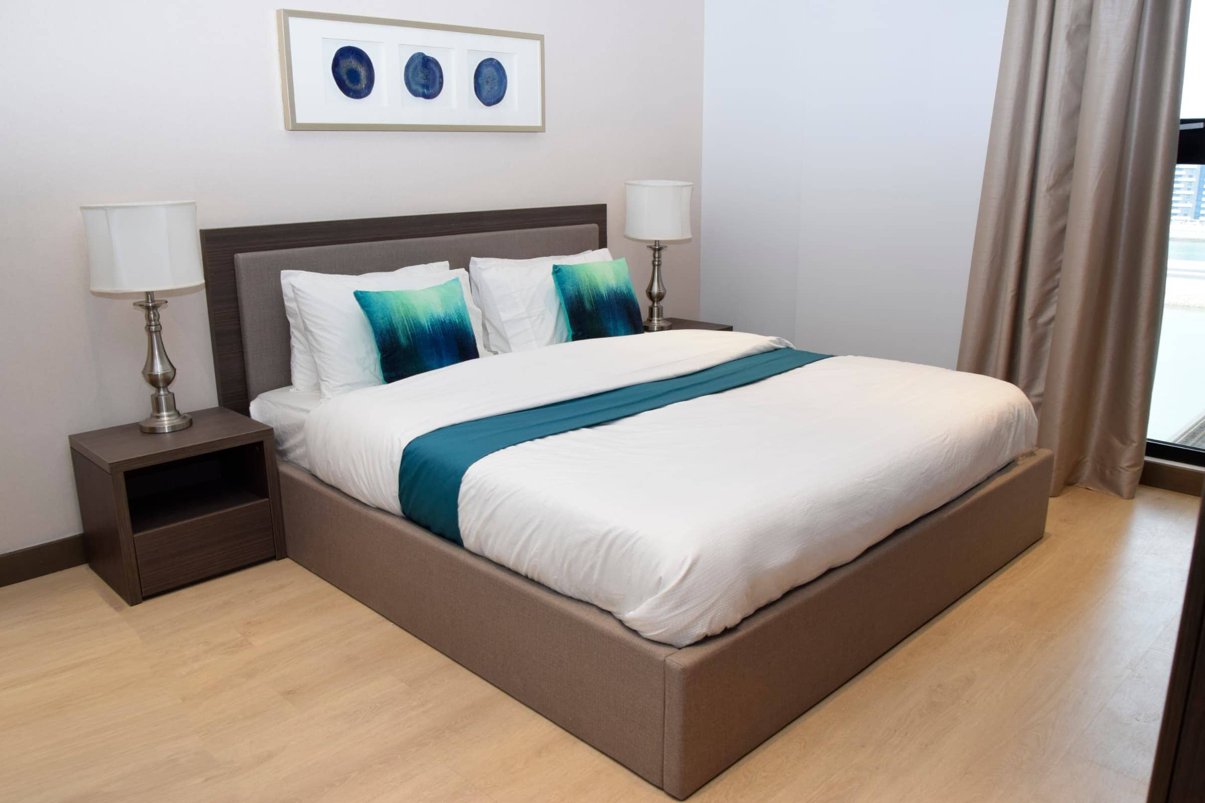 A fully furnished bedroom with a blue and white comforter.