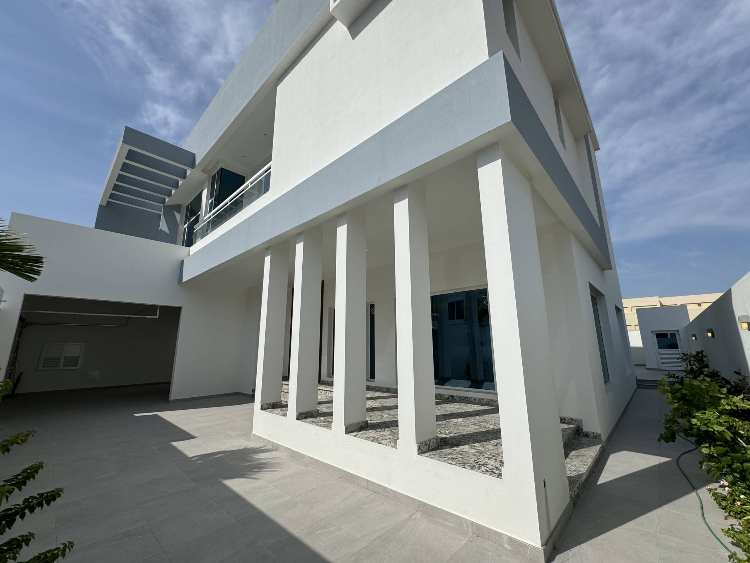 A white villa with pillars.