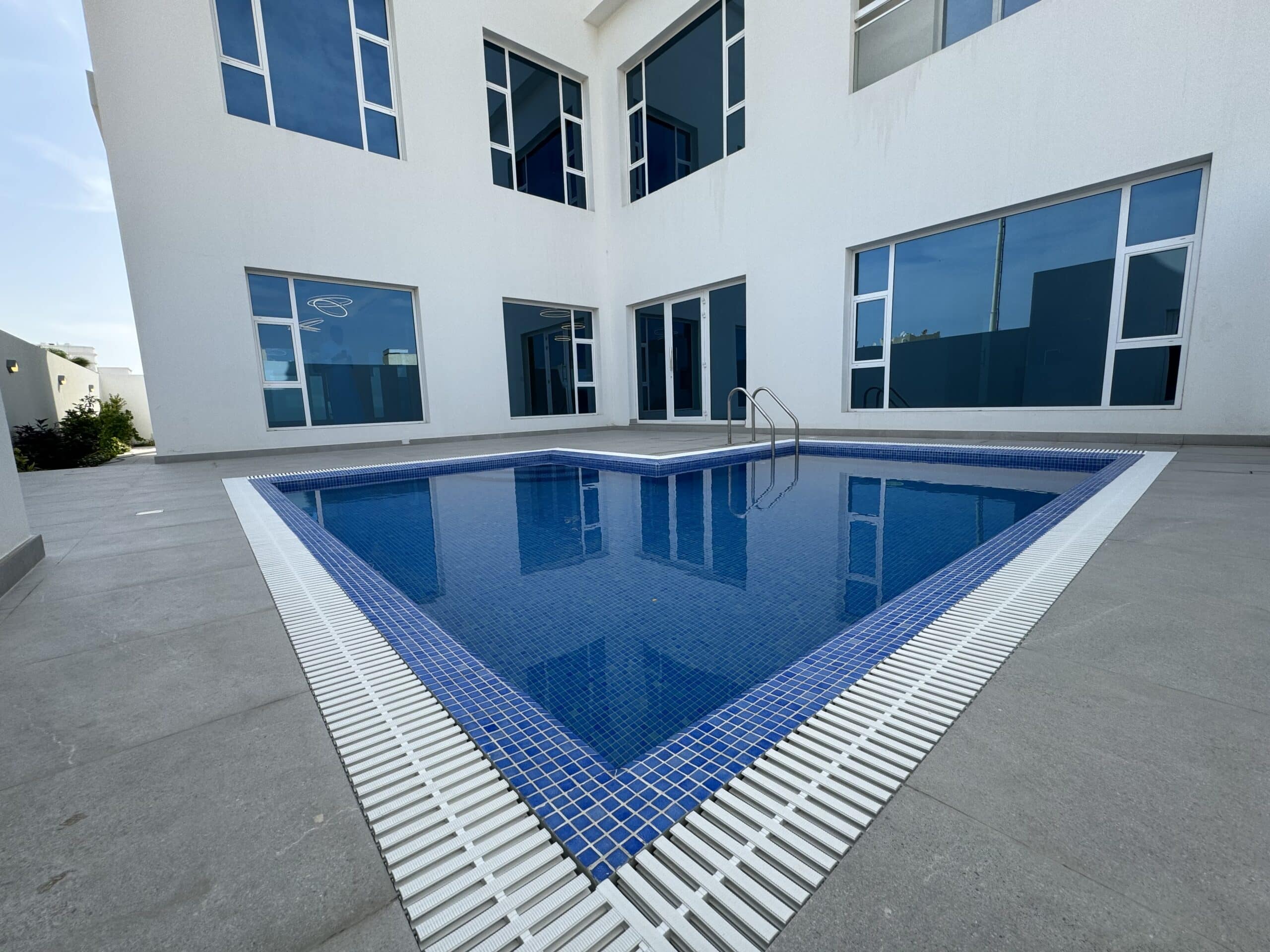 A villa with a swimming pool for sale in a building.