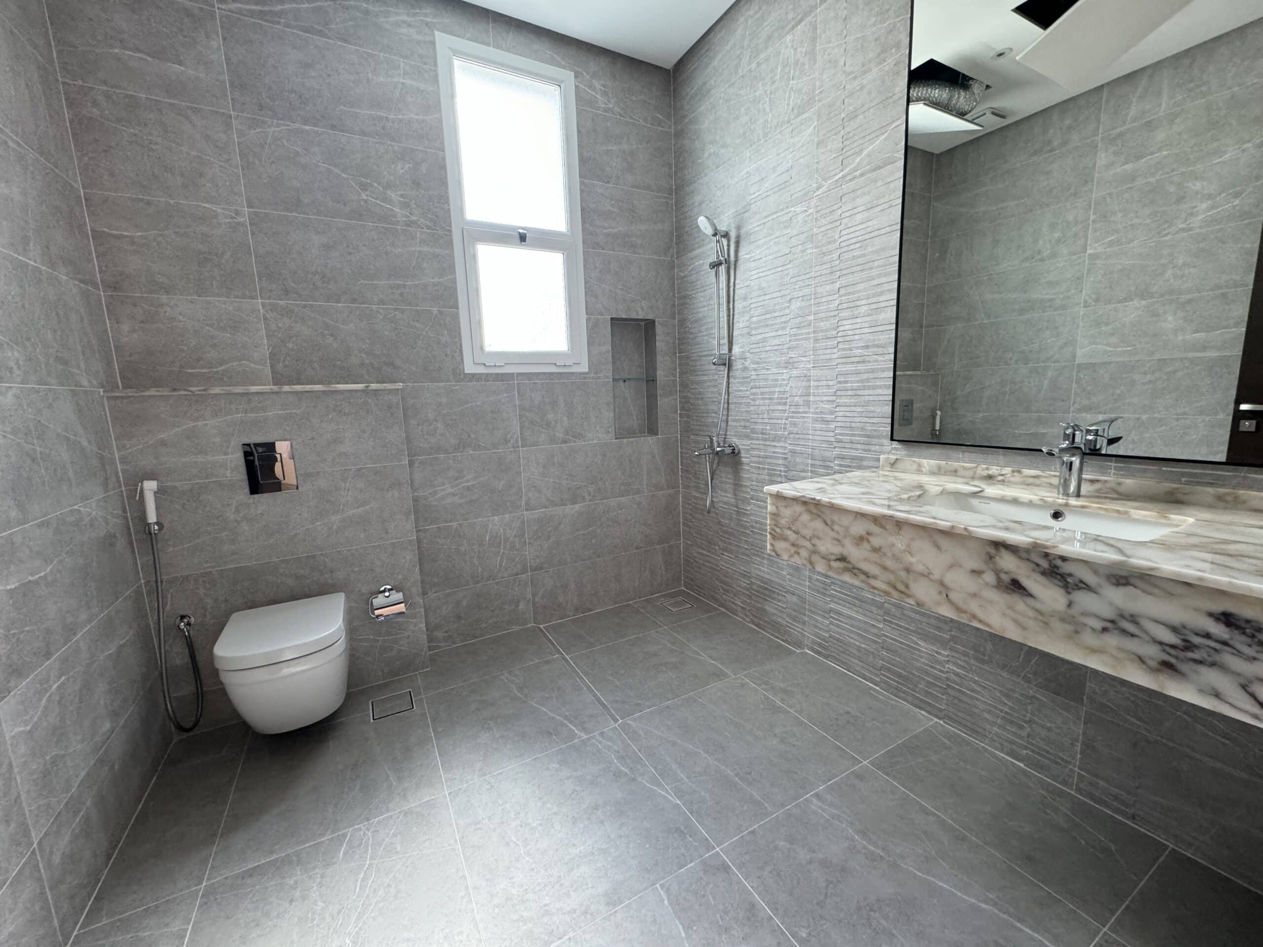 A luxurious bathroom in a villa with a sink and a mirror.