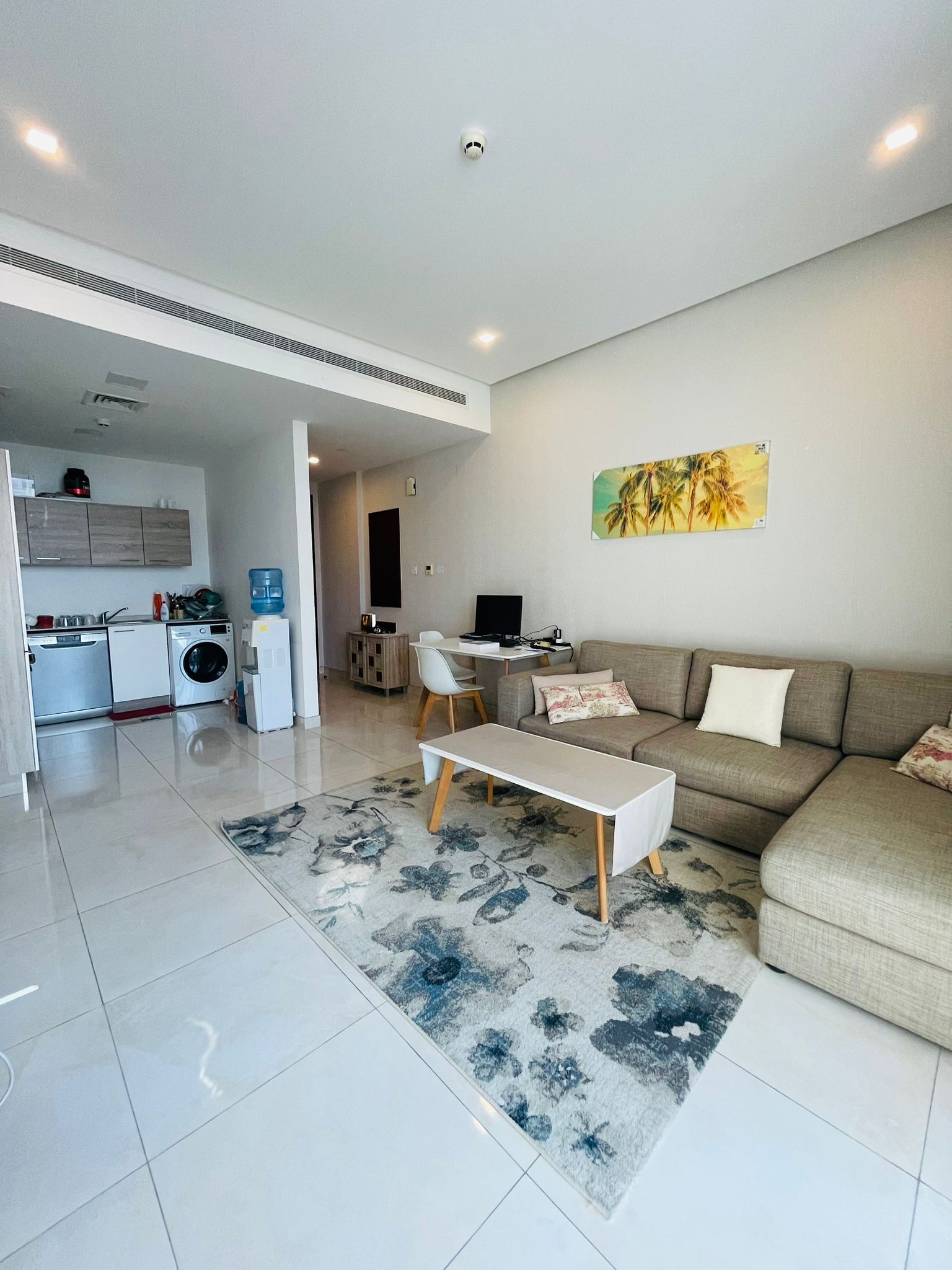 A modern living room with a luxury couch and TV.