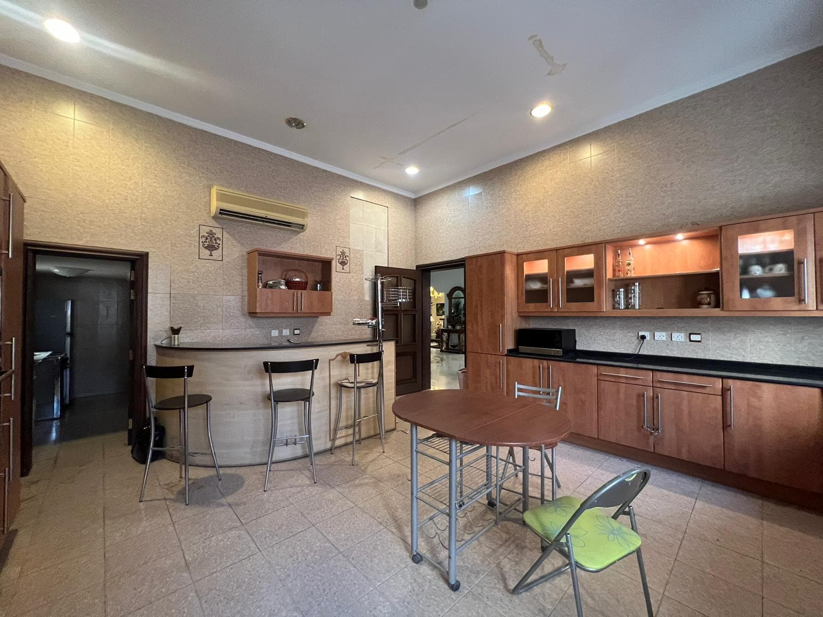 A kitchen with wooden cabinets and a bar area designed with an Auto Draft.