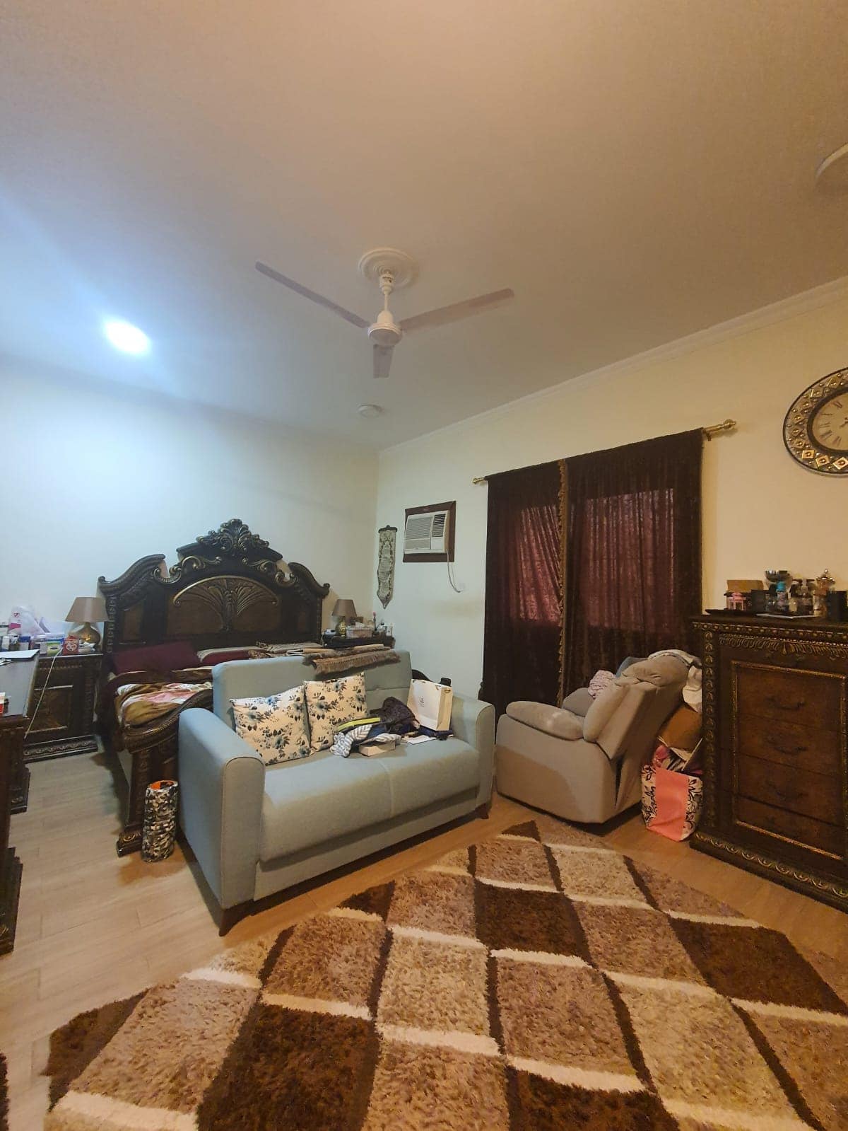 An Auto Draft living room with a couch and a fan.