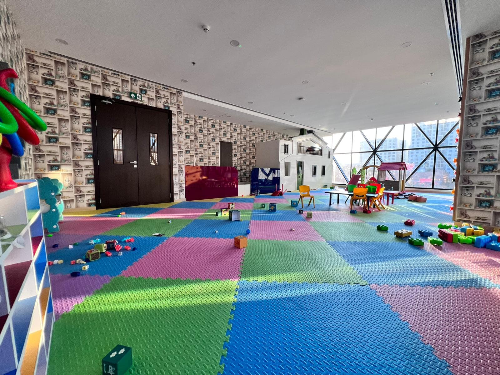 A luxury children's playroom in a Juffair bedroom gem, with colorful flooring and toys.