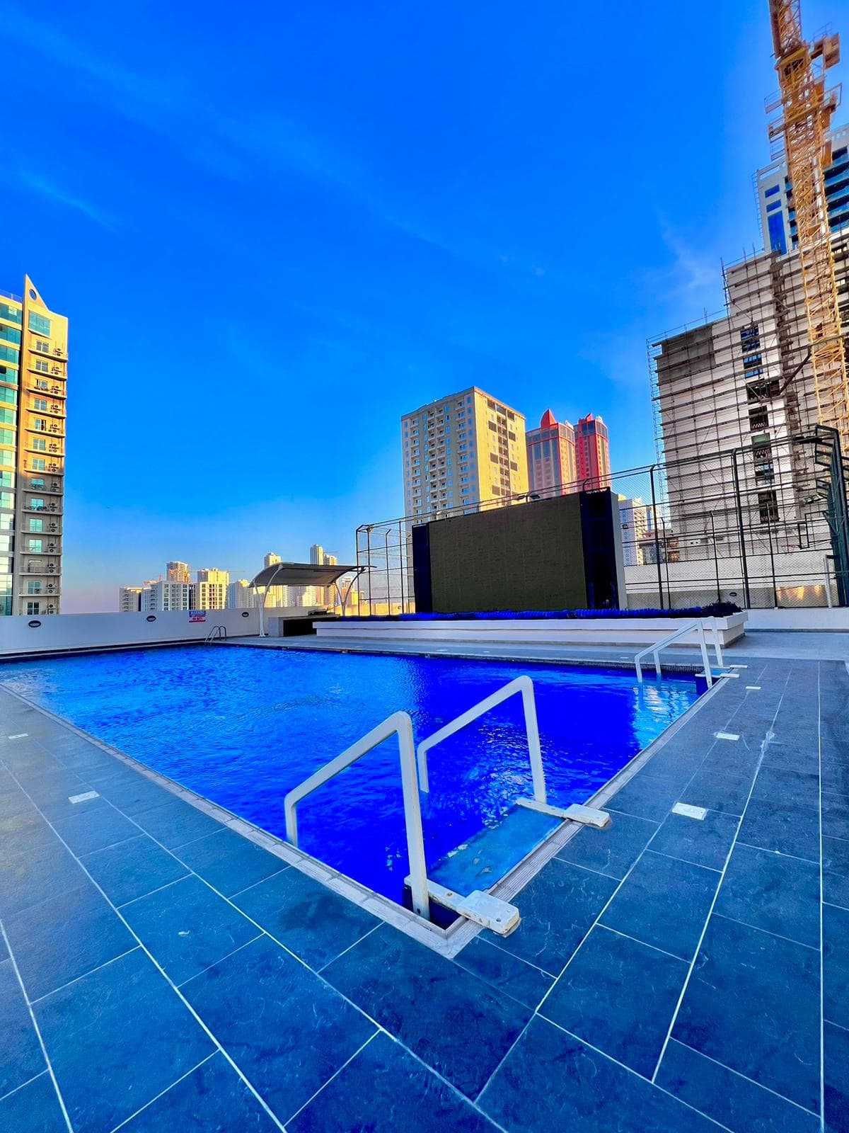 A luxurious apartment with a swimming pool in the middle of a city.