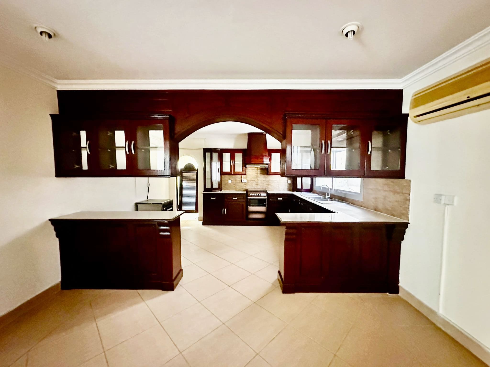 A Janusan villa with wooden cabinets and a tiled floor.