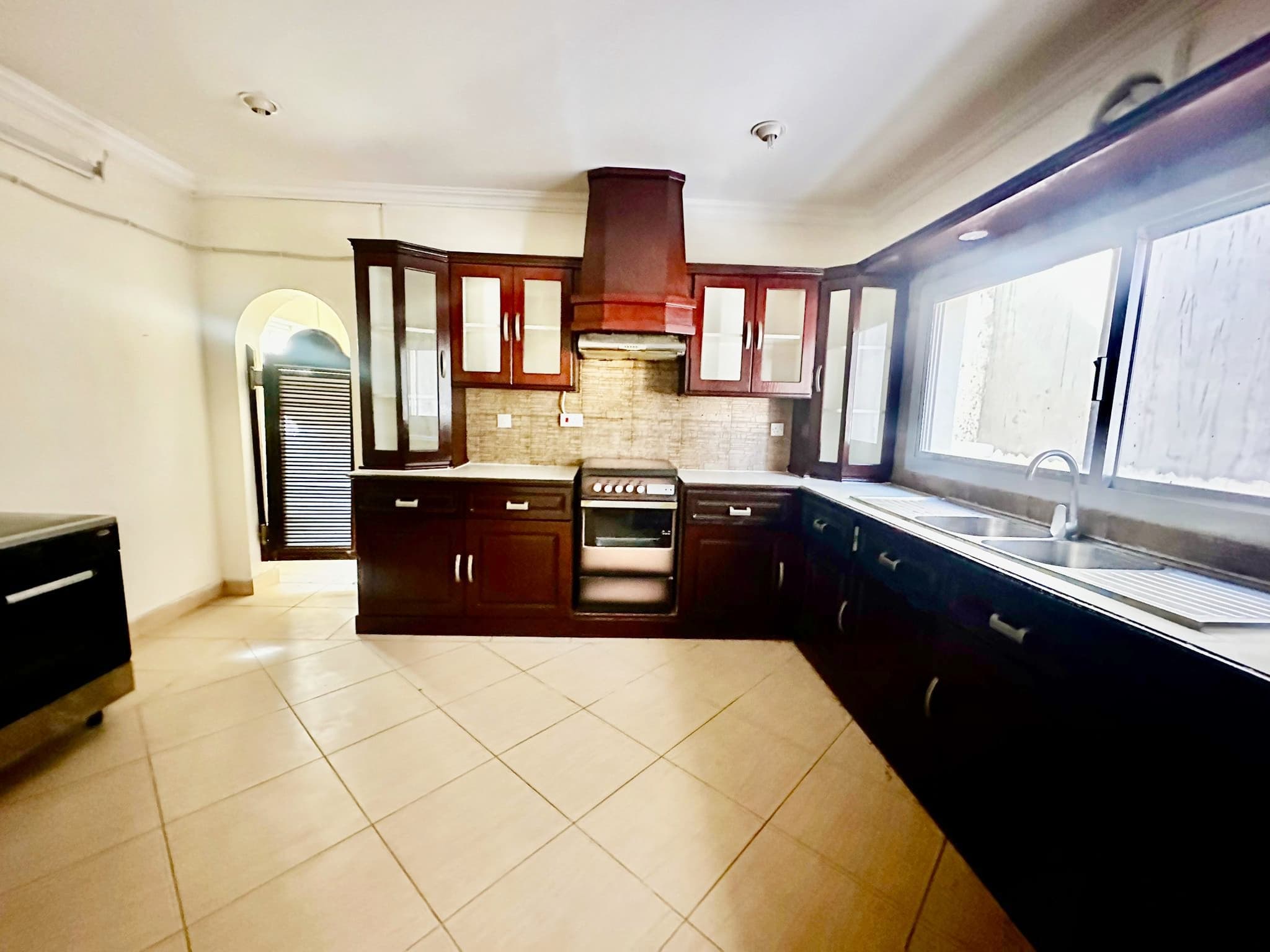 A two-story villa with a kitchen featuring a stove and sink.