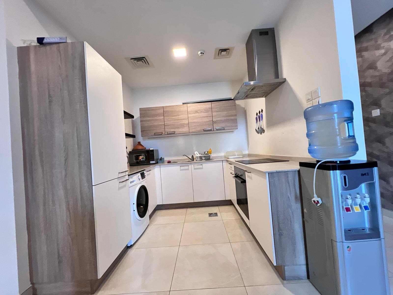 A white kitchen with cabinets and appliances.