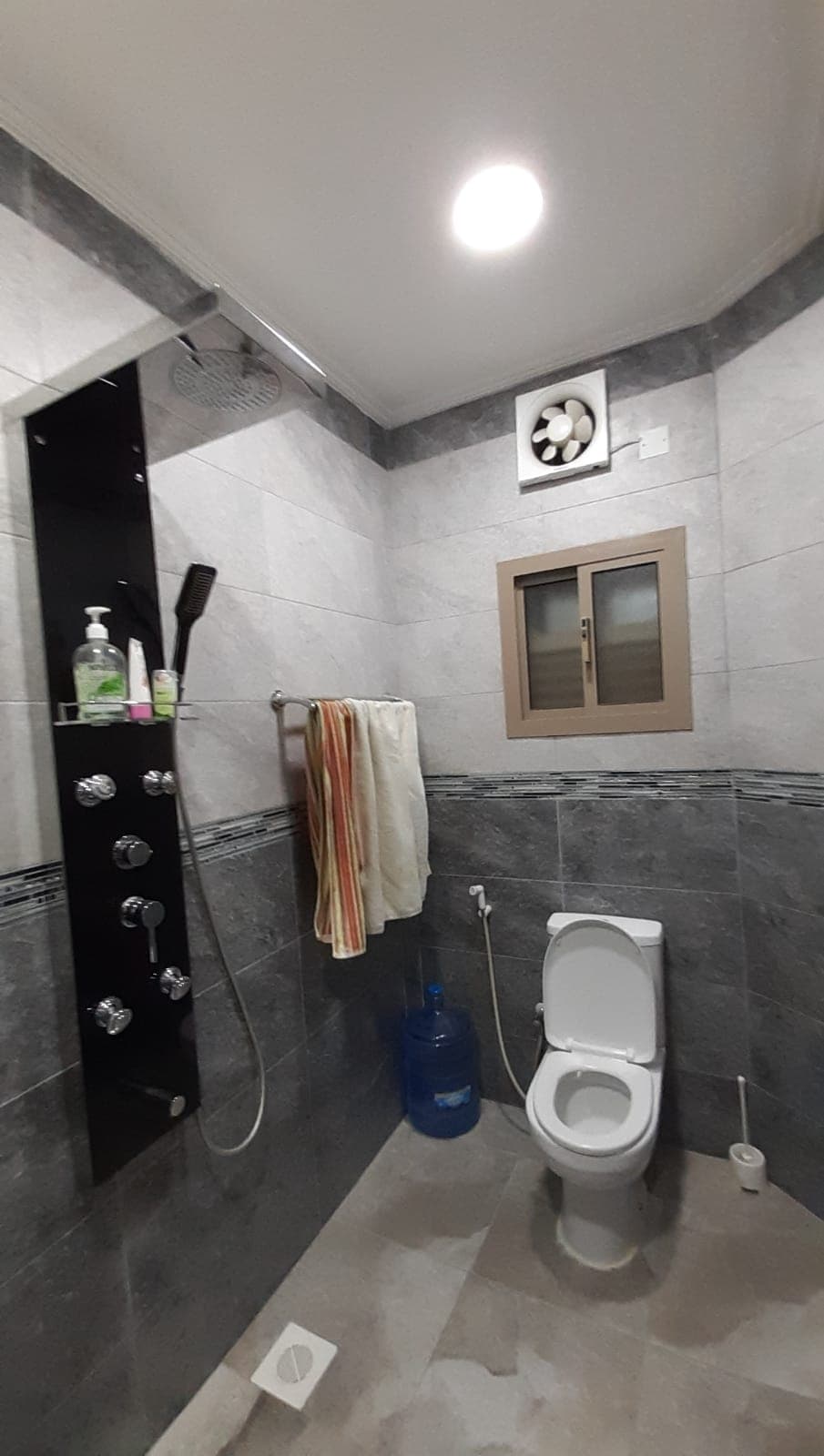 An apartment in Samaheej for sale featuring a bathroom with a shower and toilet.