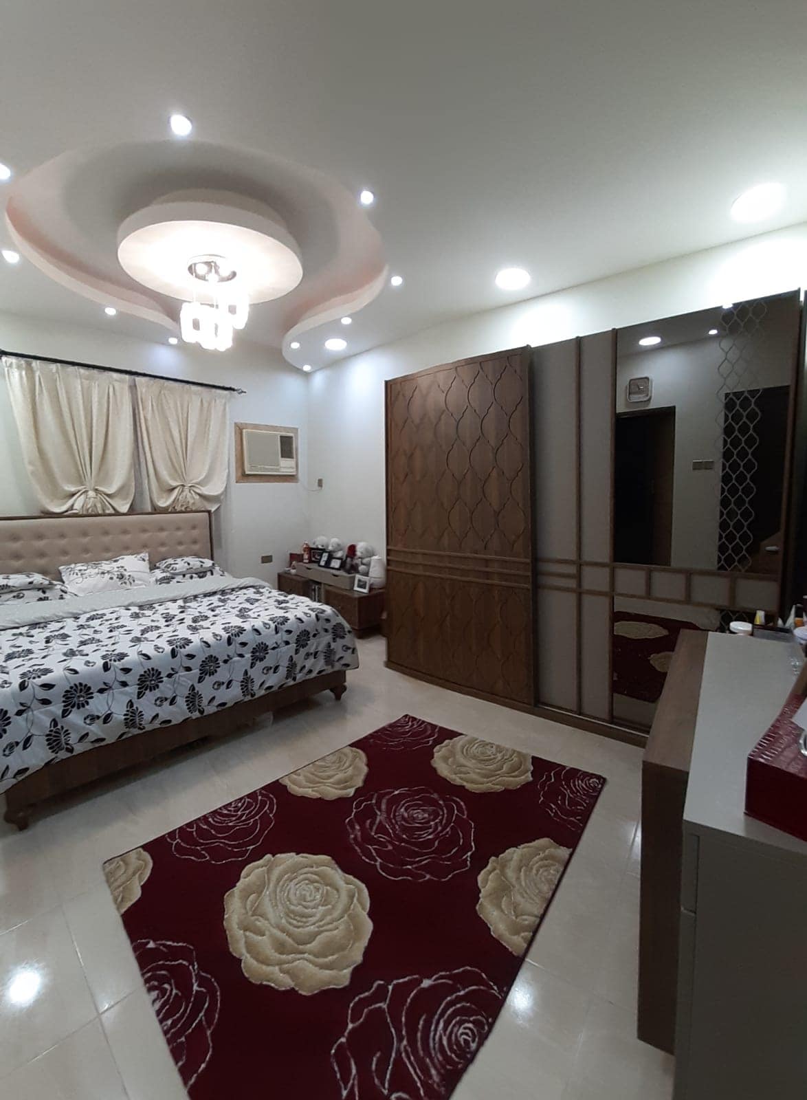 Apartment for sale in Samaheej with a bed and a mirror.