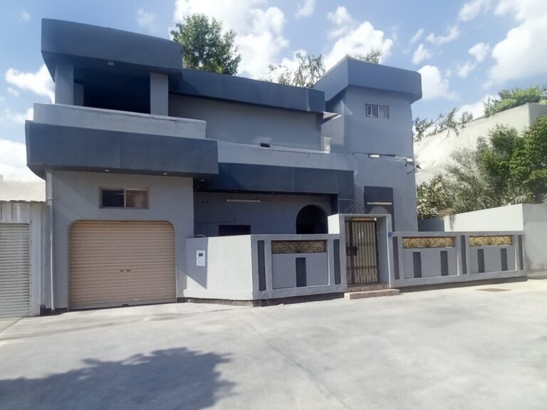 A villa with a garage in front of it for sale in Hamad Town.