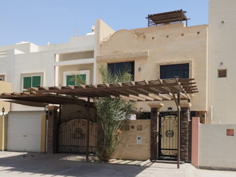A luxury villa in a residential area with a gated entrance is available for sale.