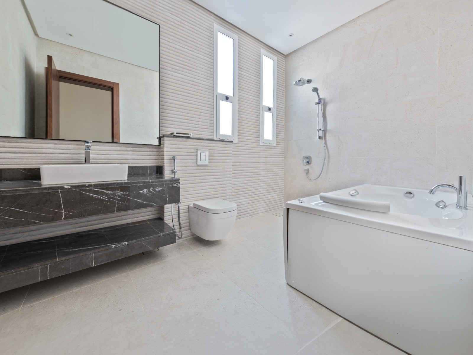 A bathroom with a tub and a sink is available for sale in the villa.