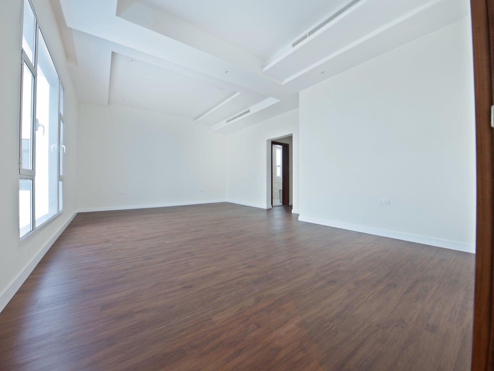 A room with white walls and a wood floor.