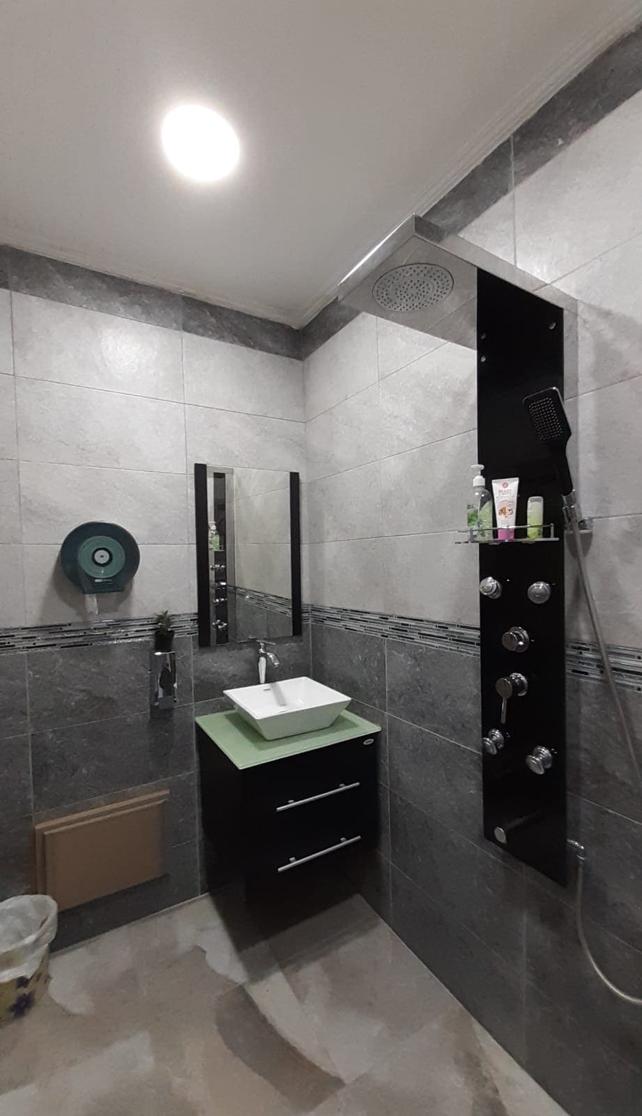 An apartment in Samaheej for sale with a shower, sink, and toilet.