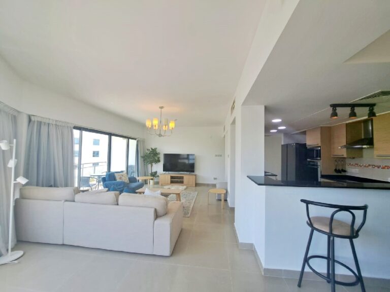 A modern apartment living room and kitchen area in Amwaj.