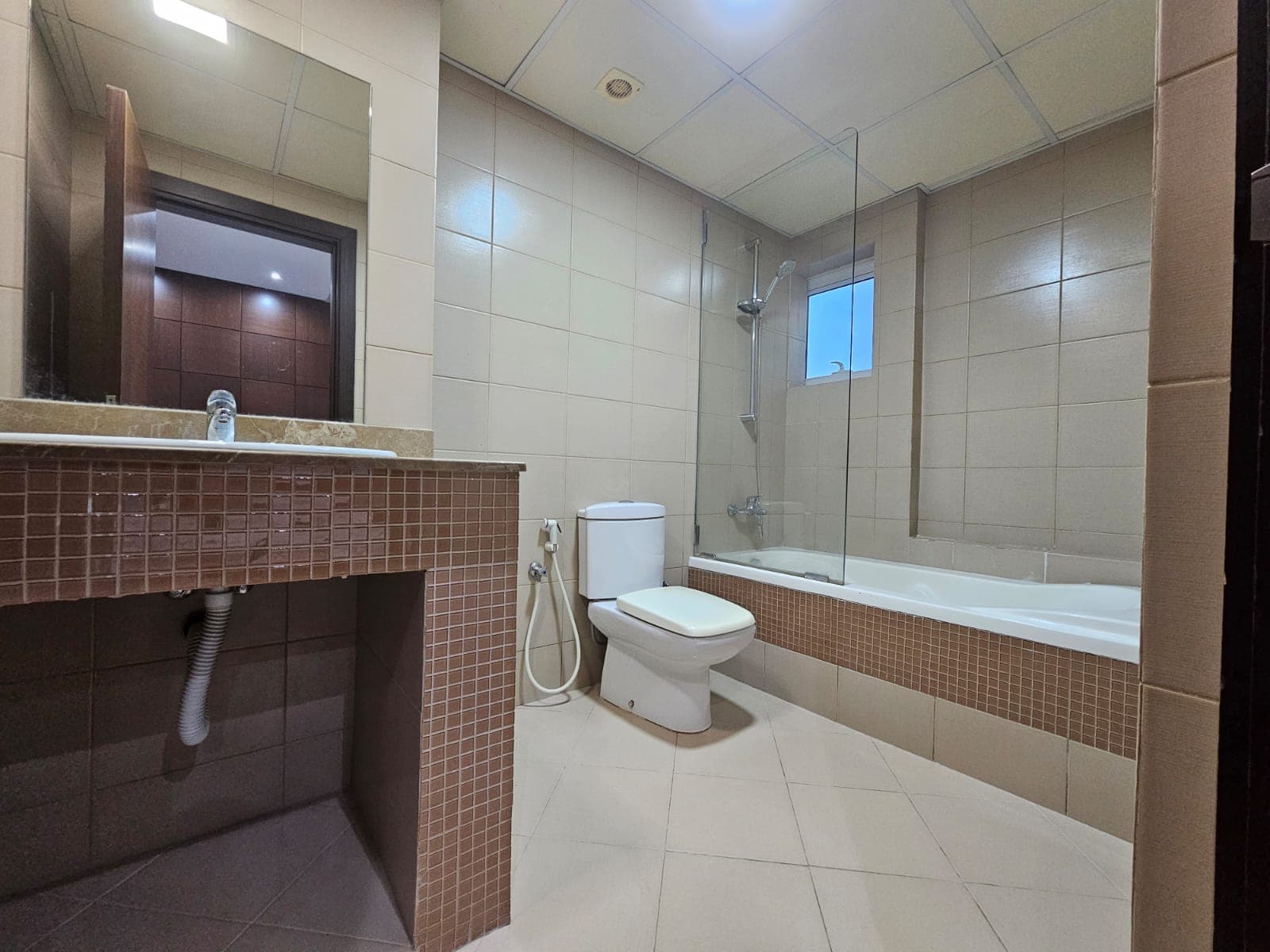 A flat with a bathroom equipped with a toilet, sink and shower available for rent in Juffair.