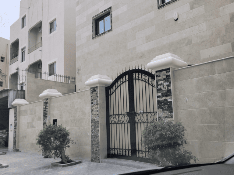 A villa with a gate and a building located in the Al-Hajiyat area.
