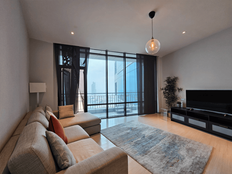 A modern living room with a screen TV and a breathtaking view of the city, Rent a Flat in Seef Area .