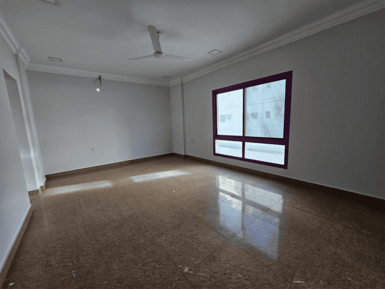 An empty room with tile floors and a ceiling fan available for rent.
