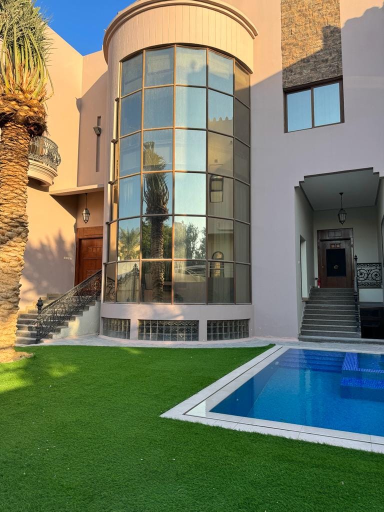 A villa with a swimming pool in front of it available for rent in Juffair.