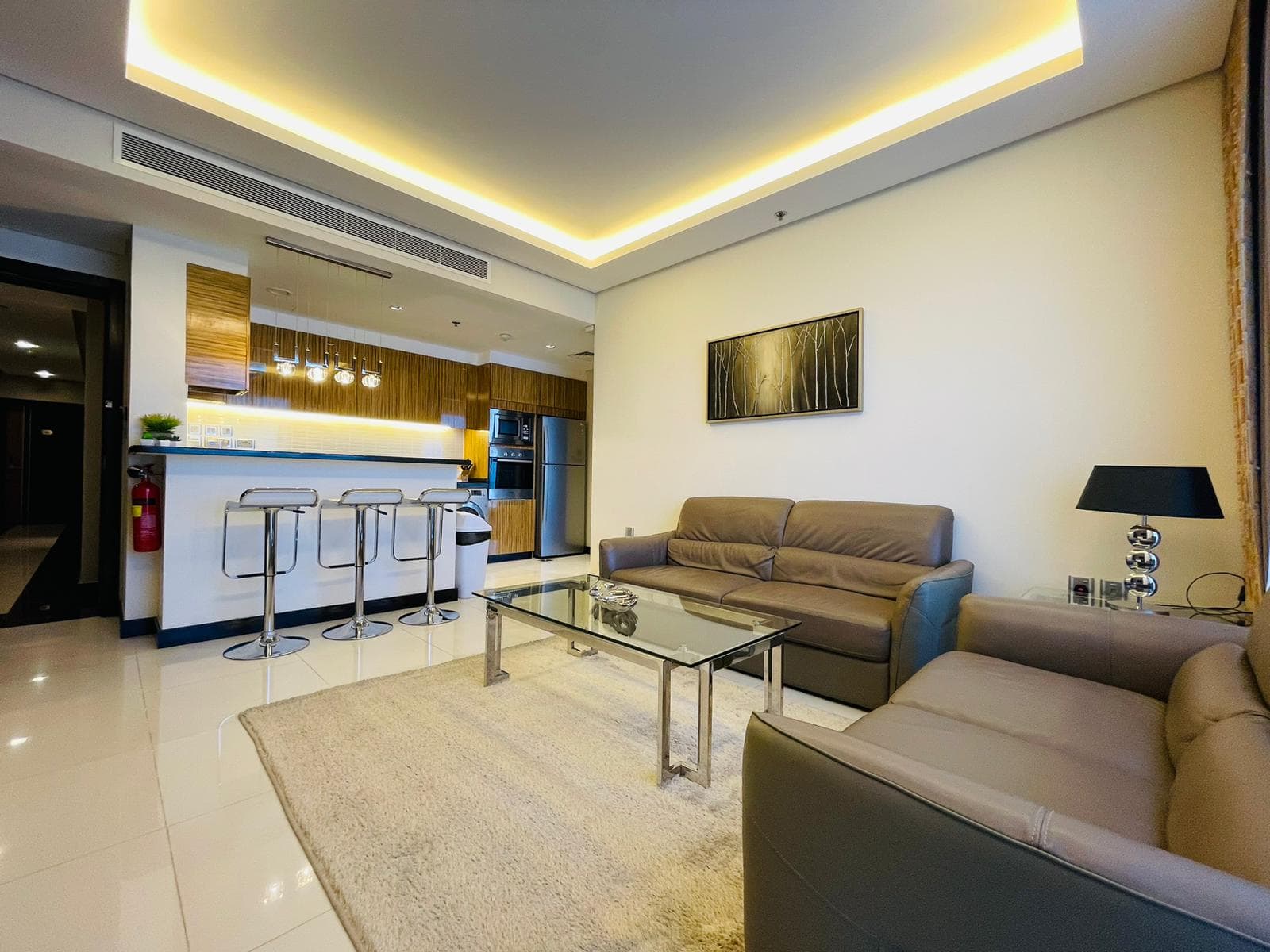 A luxury 1BR apartment with a living room and kitchen area in the Seef district.