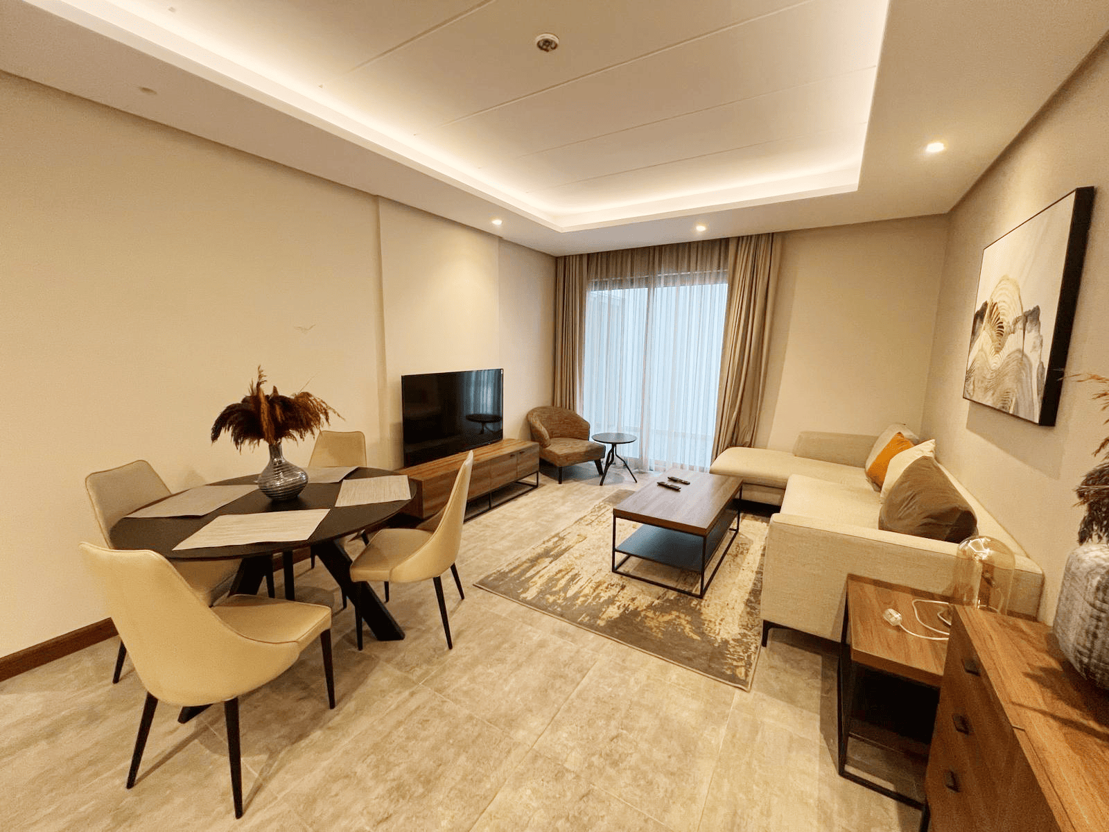 A luxury modern apartment with a fully furnished living room and dining area.