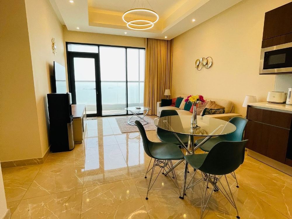 A living room and dining area with a view of the ocean, Auto Draft.