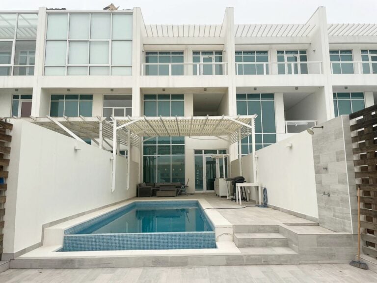Modern residential building with an Auto Draft swimming pool.