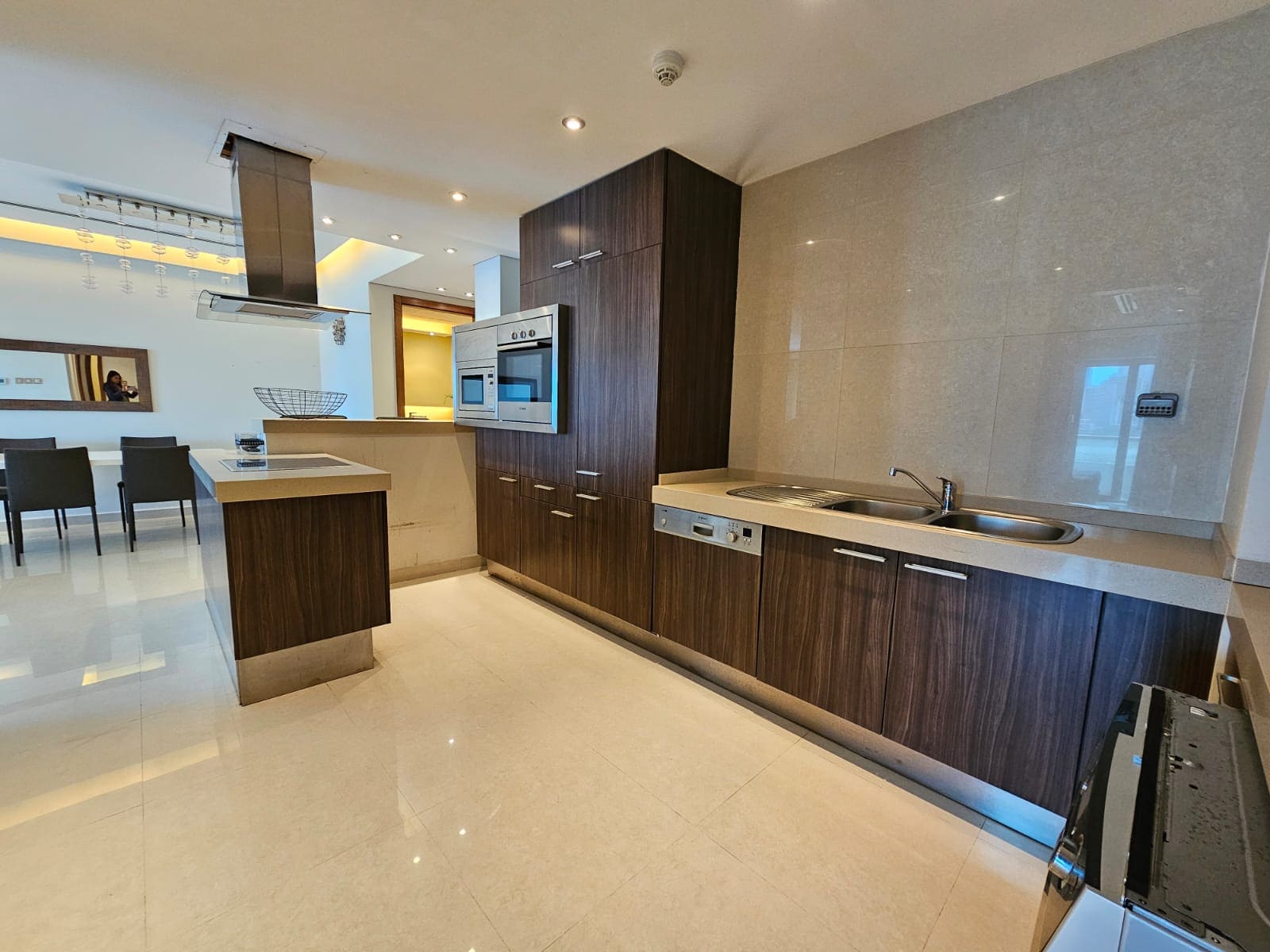 Modern kitchen interior with built-in appliances and a central island.