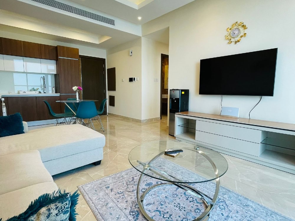 A living room with a flat screen tv, an auto draft system, and a coffee table.