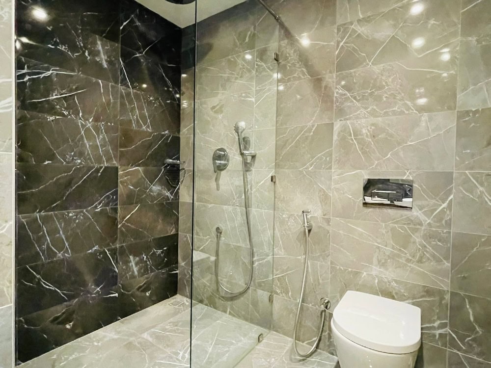 A bathroom with a glass shower stall, a toilet, and Auto Draft.