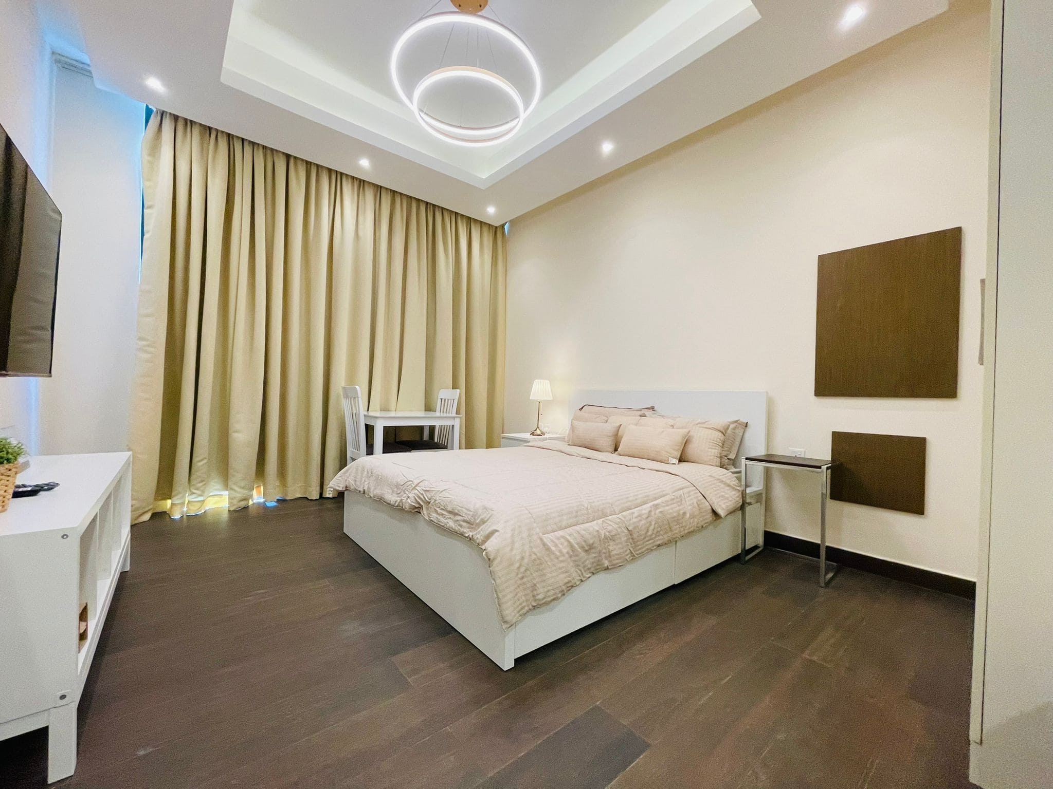 A modern living bedroom in Juffair with a bed, and a table and chairs.