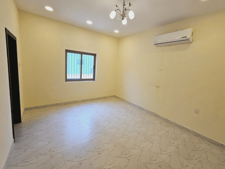 Apartment for rent with an empty room, yellow walls, tile flooring, a window, and an air conditioning unit in Saar.