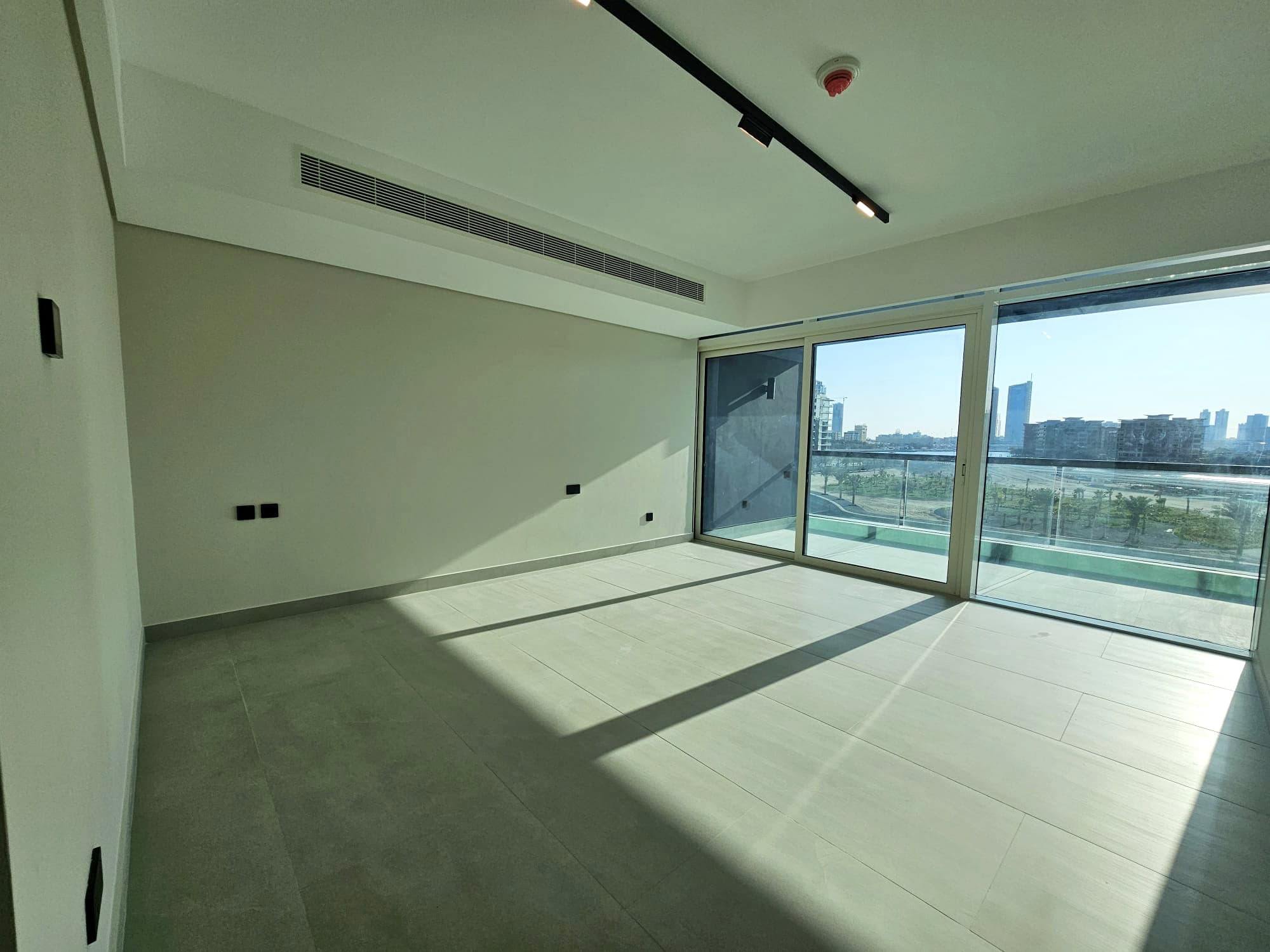 Empty modern apartment room with large windows, city view, and auto draft.