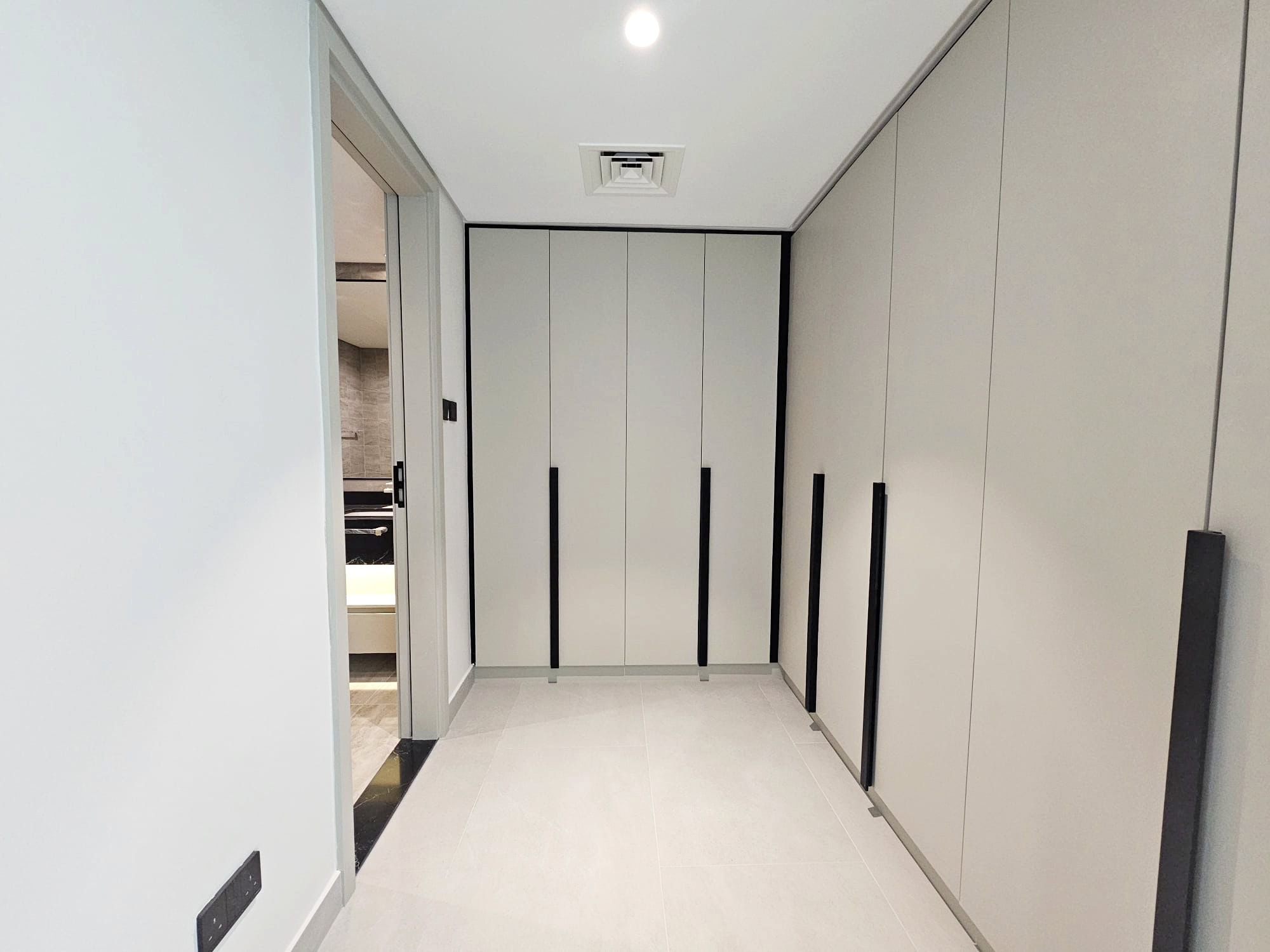 A modern corridor with white walls and Auto Draft sliding doors.