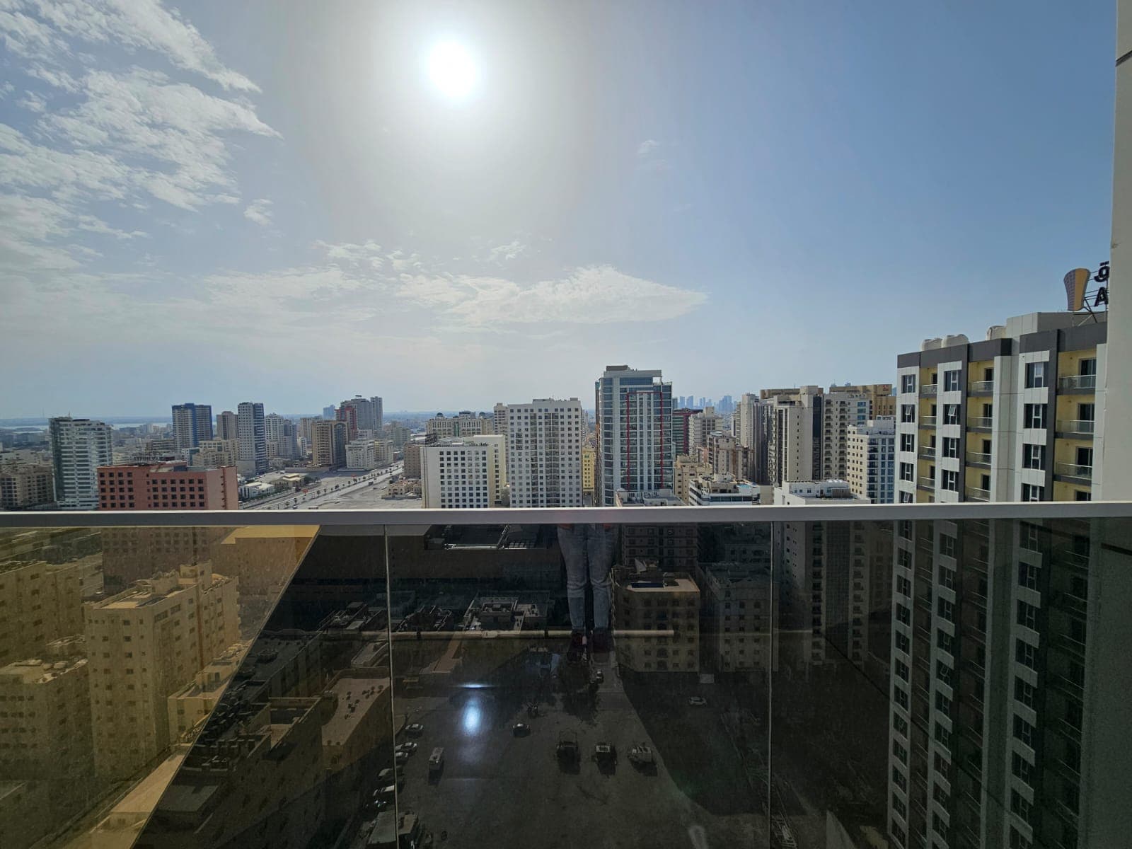 Cityscape view from a high-rise balcony on a sunny day, Auto Draft.