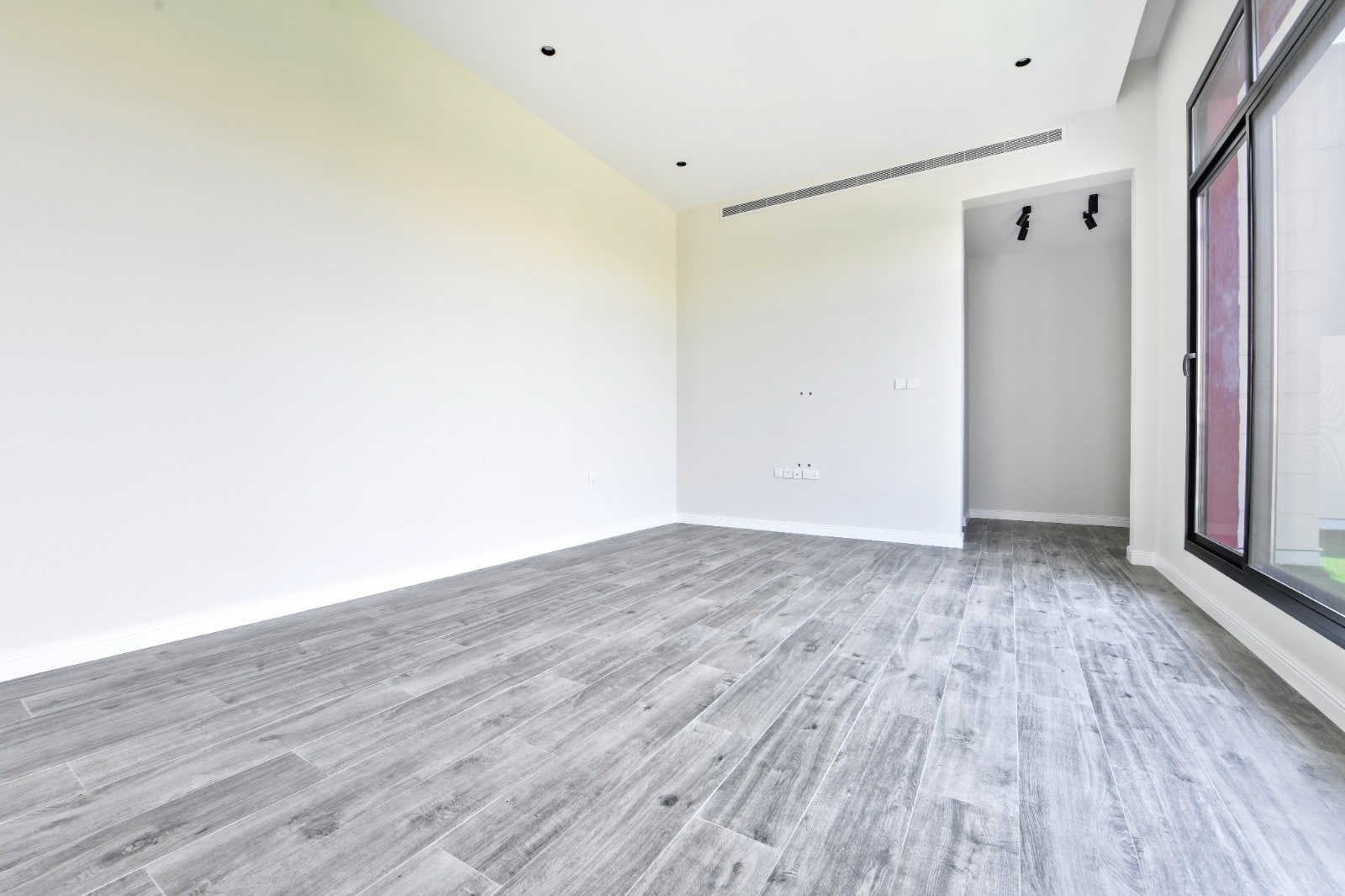 Auto Draft: Empty modern room with grey flooring and white walls with large window.